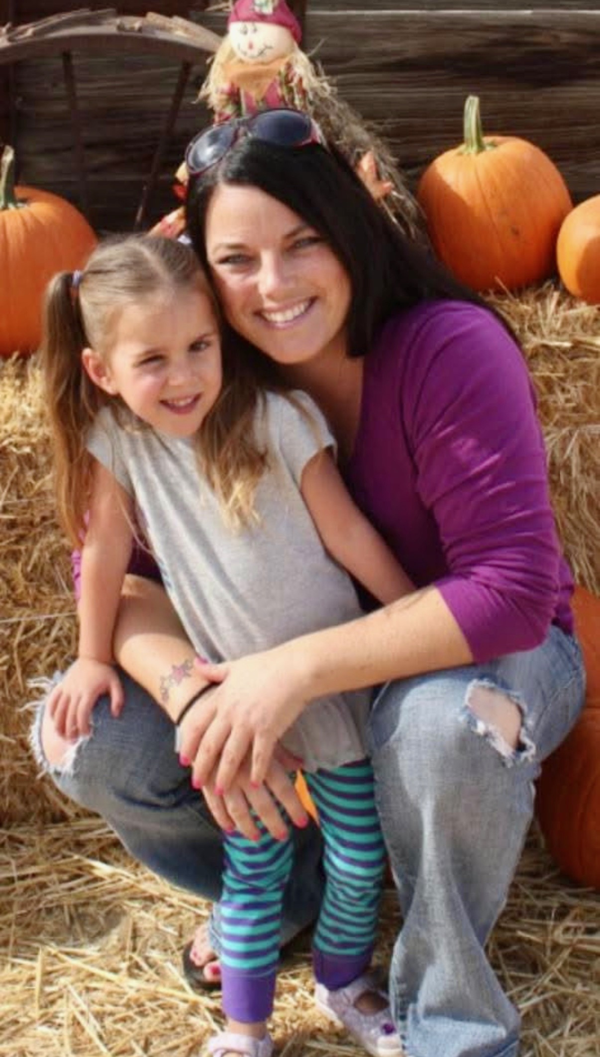 Lily as a young child with Jennifer at a pumpkin patch