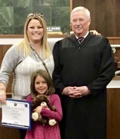 Lily as a young child with Jennifer at a pumpkin patch